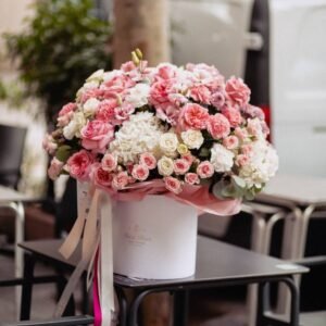 Bouquet in delicate colours in a box