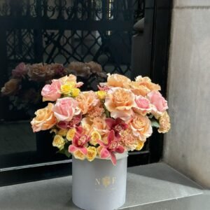 Rosas naranjas y orquídeas en caja
